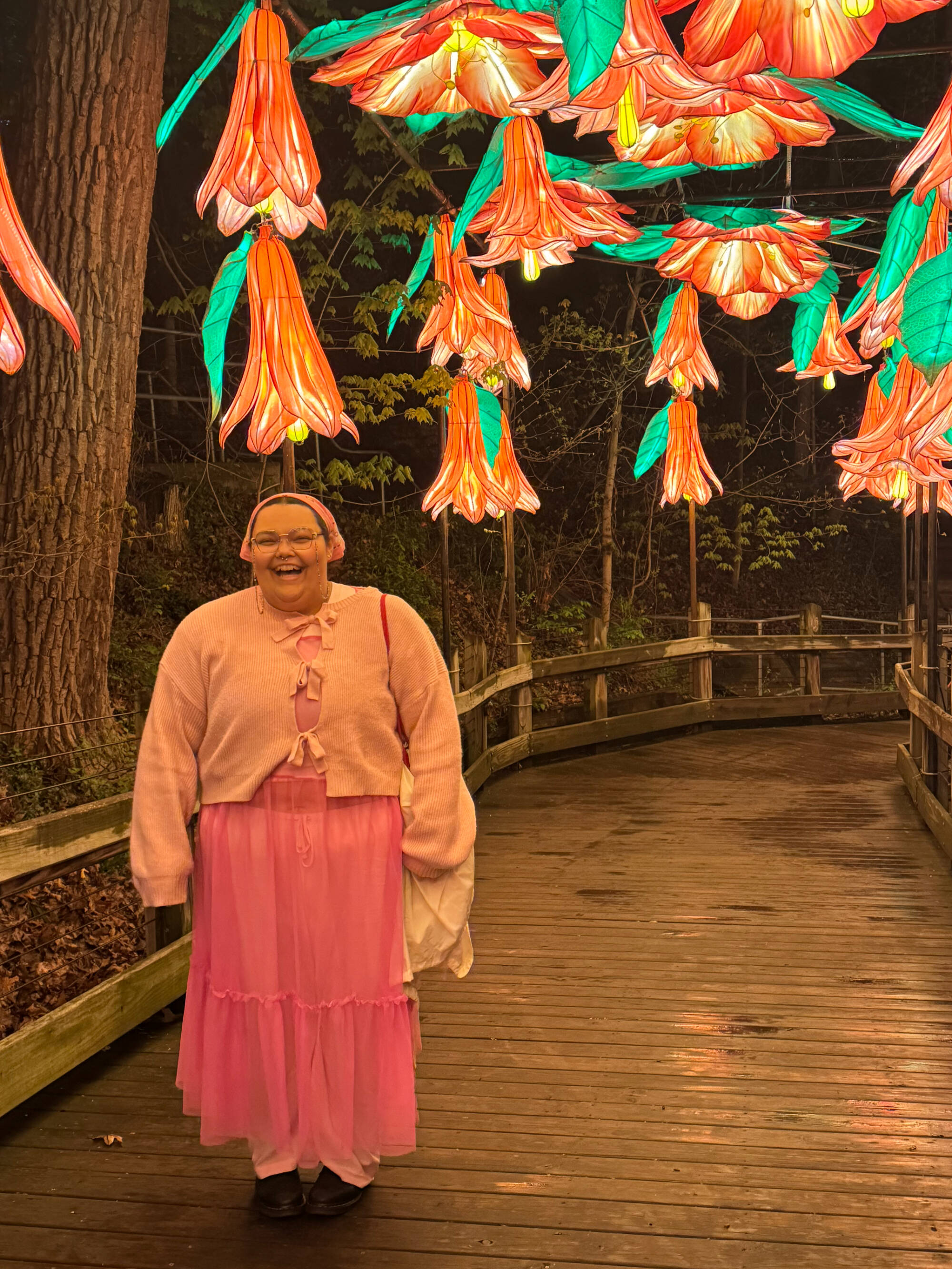 Charlee stands grinning under the lantern flowers at John Ball Zoo lantern festival!